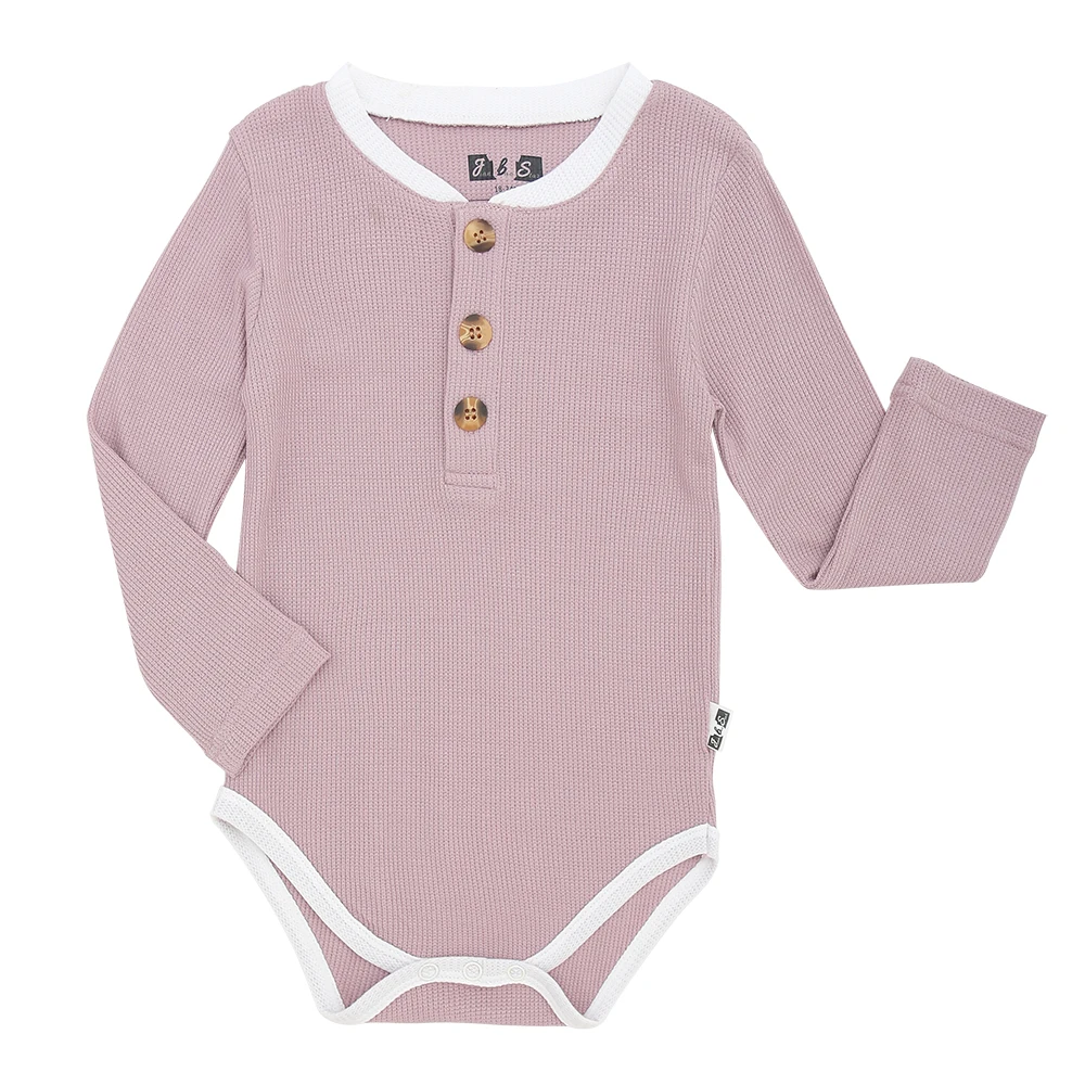 Eco-friendly adult bamboo joggers displayed on a wooden rack, ideal for B2B wholesale buyers seeking sustainable apparel solutions.